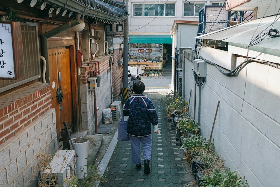 Myeongdong-gil shopping corridor with cathedral spire visible in the distance — editorial photograph, Seoul Aesthetic Guide district reading